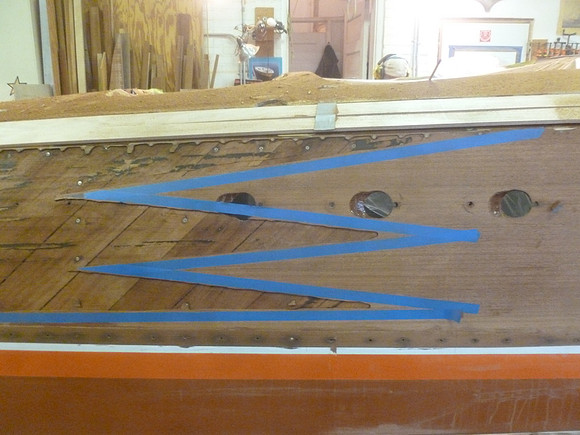 Blue tape lines identify usable outer laminate, right, and areas to be replaced, left, with old laminate removed